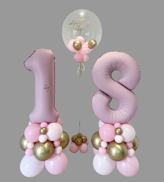 Pink and gold balloon decorations with number '18' for a celebration.