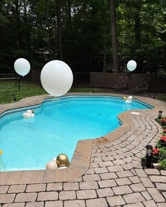 Pool over sized Helium Balloons