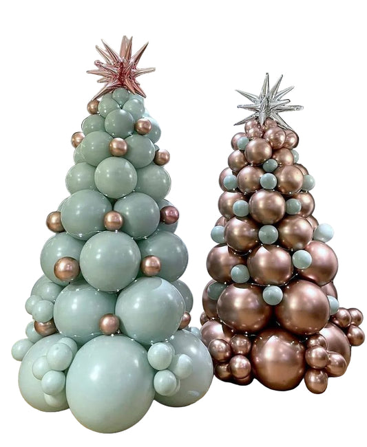 Two balloon trees, one green and one rose gold, in a room setting.