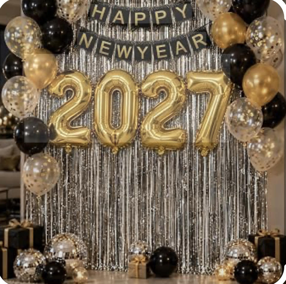 New Year 2027 party backdrop with gold foil balloon numbers, a black banner reading Happy New Year, silver tinsel fringe, and black and gold balloon garlands.